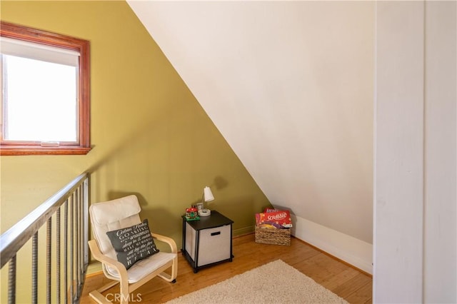 additional living space with light hardwood / wood-style flooring and vaulted ceiling