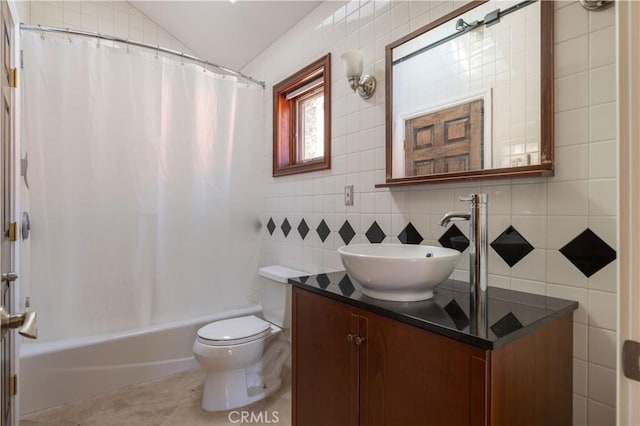 full bathroom with vanity, tile patterned flooring, toilet, tile walls, and shower / tub combo