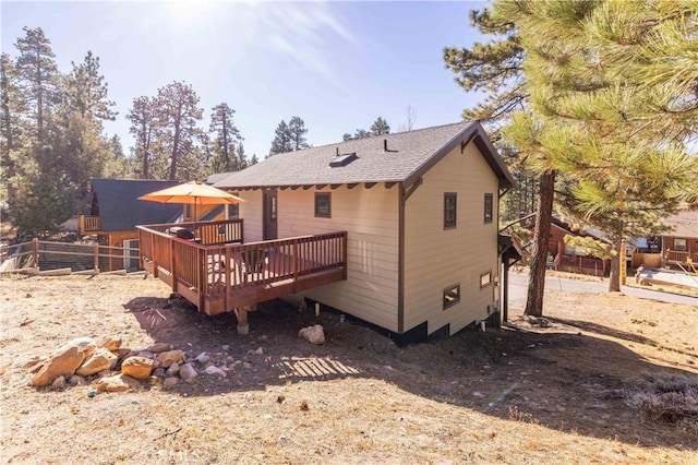 rear view of property featuring a deck