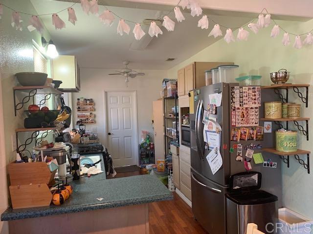 kitchen with stainless steel fridge, dark hardwood / wood-style floors, and ceiling fan