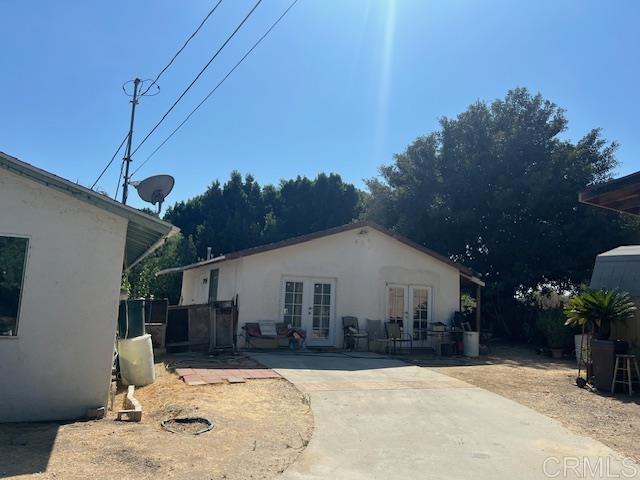 rear view of property with french doors and a patio