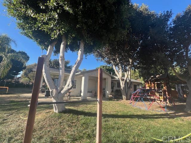 exterior space with a playground and a front yard