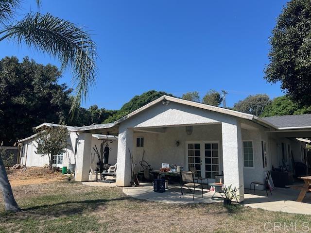 back of property with a patio area