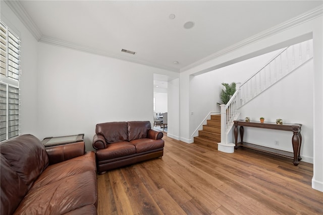 living room with hardwood / wood-style flooring and crown molding