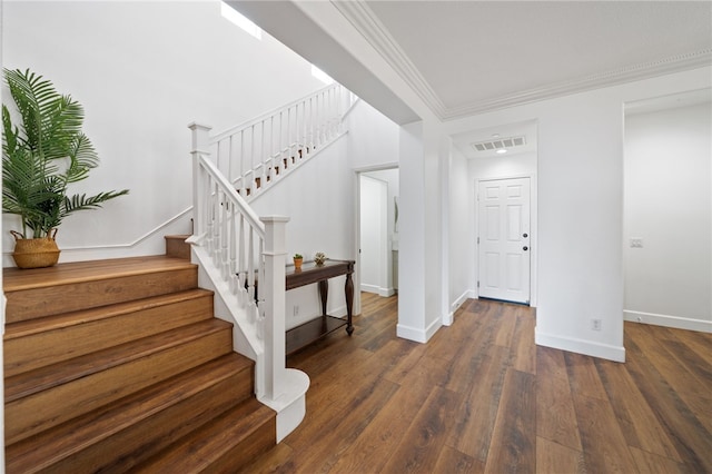 entrance foyer with crown molding and dark hardwood / wood-style floors