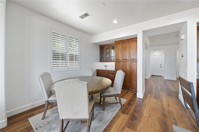 dining space featuring dark hardwood / wood-style flooring