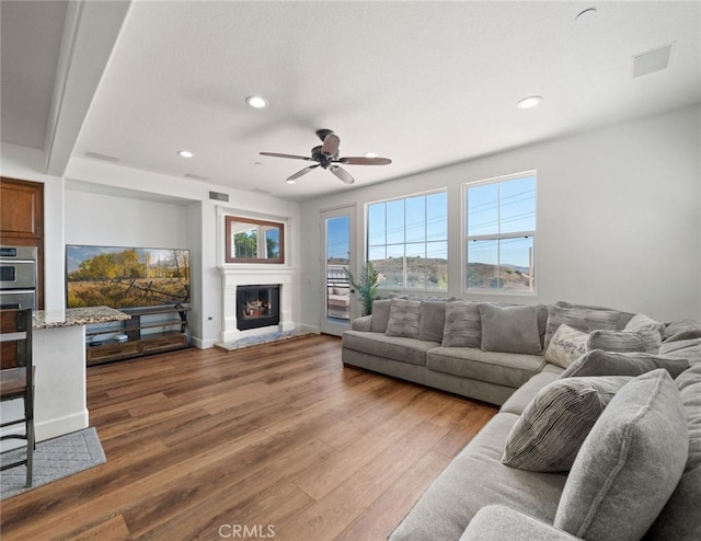 living room featuring ceiling fan and hardwood / wood-style floors