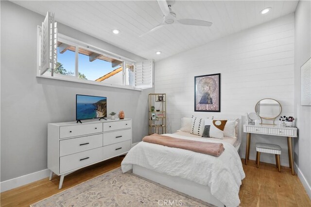 bedroom featuring light wood-type flooring, ceiling fan, and wooden ceiling