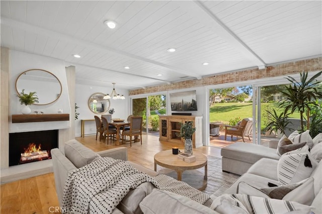 living room with wood ceiling, light hardwood / wood-style floors, and an inviting chandelier