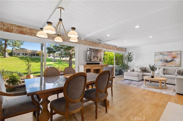 dining area with beam ceiling, wooden ceiling, and light wood-type flooring