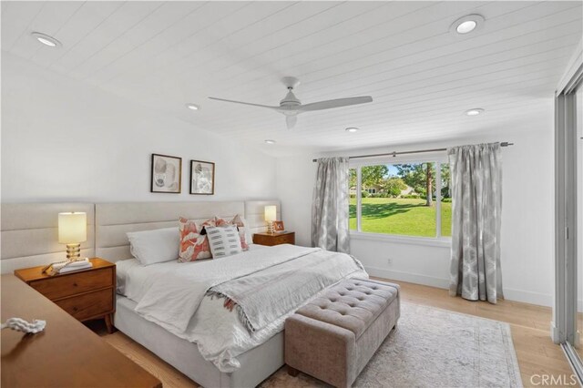 bedroom featuring ceiling fan, light hardwood / wood-style floors, and wooden ceiling