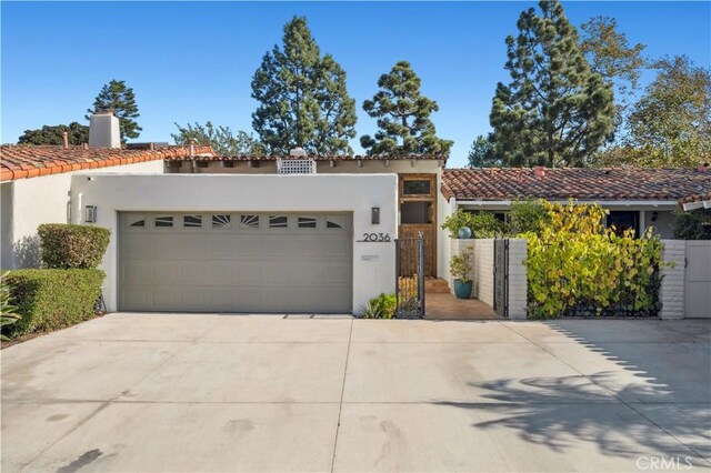 mediterranean / spanish home featuring a garage