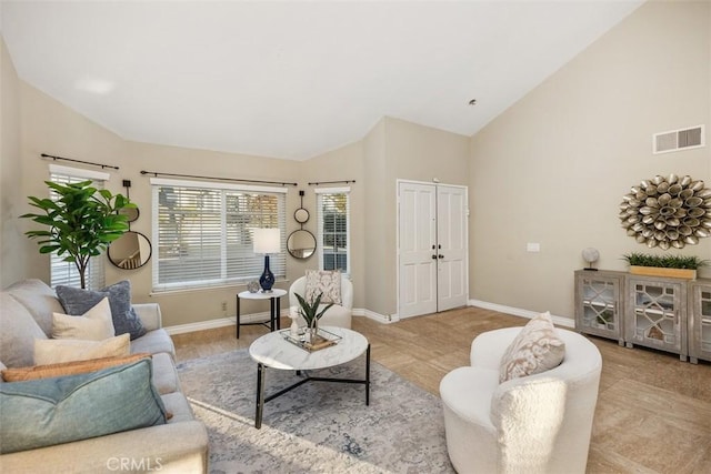 living room featuring high vaulted ceiling and light hardwood / wood-style floors