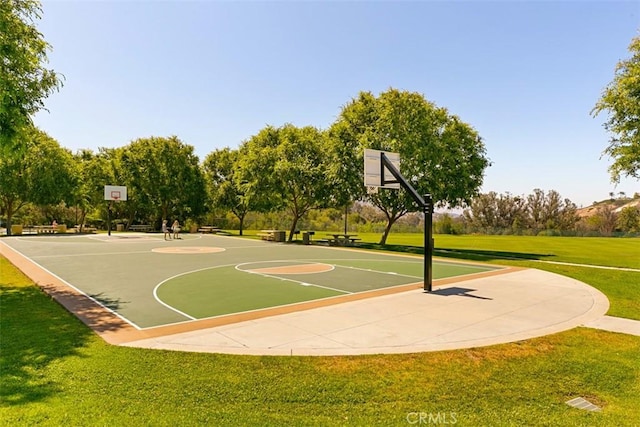 view of basketball court featuring a lawn