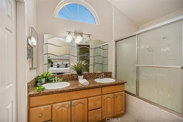 bathroom with vanity, enclosed tub / shower combo, and vaulted ceiling