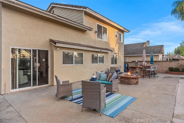 view of patio / terrace featuring an outdoor living space with a fire pit