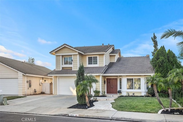 front of property featuring a garage and a front lawn