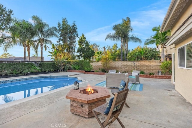 view of pool featuring a patio and an outdoor fire pit