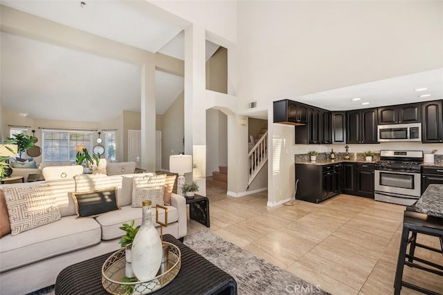 living room featuring high vaulted ceiling