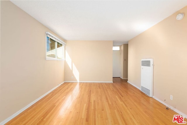 empty room with light hardwood / wood-style flooring