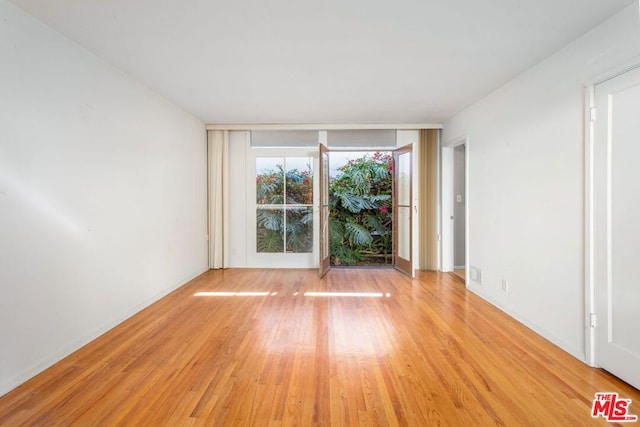 unfurnished room with light hardwood / wood-style floors