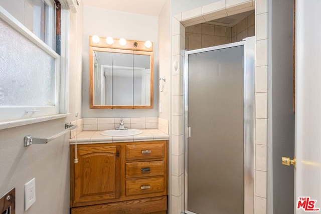 bathroom with vanity and walk in shower