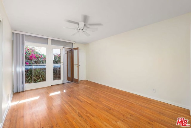 unfurnished room featuring light hardwood / wood-style flooring and ceiling fan