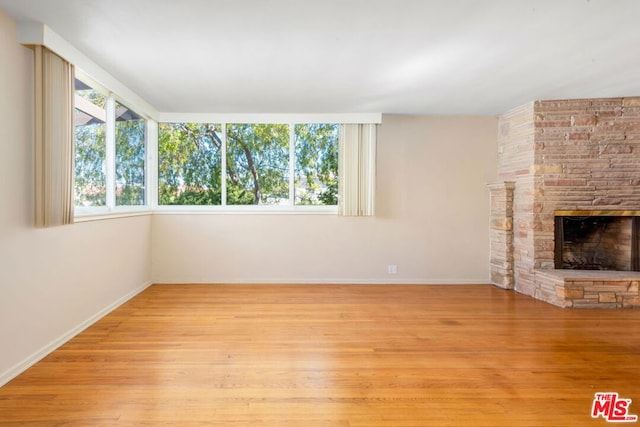 unfurnished living room featuring light hardwood / wood-style floors and a fireplace