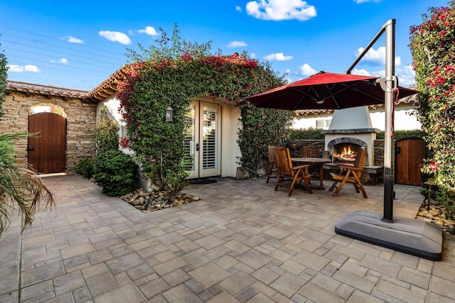 view of patio featuring exterior fireplace