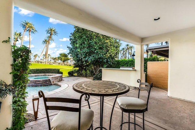 view of patio / terrace with a pool with hot tub