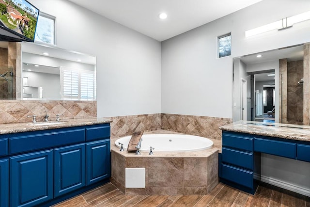 bathroom with vanity, a healthy amount of sunlight, and wood-type flooring