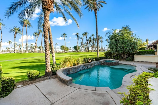 view of pool with a lawn and an in ground hot tub