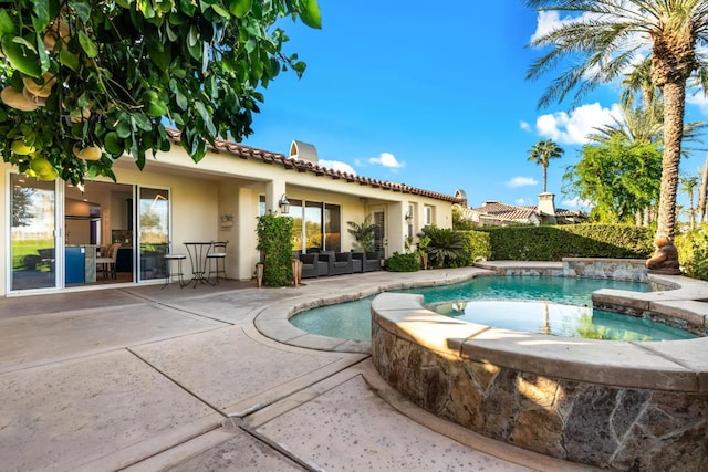 view of pool with an in ground hot tub and a patio