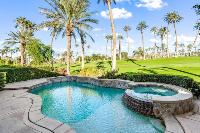 view of swimming pool featuring a lawn and an in ground hot tub