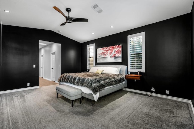 bedroom with ceiling fan, carpet floors, and lofted ceiling