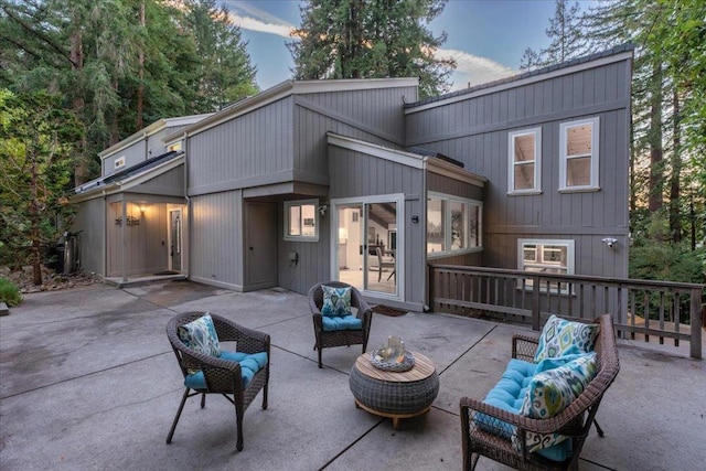 rear view of property featuring a patio area and an outdoor living space