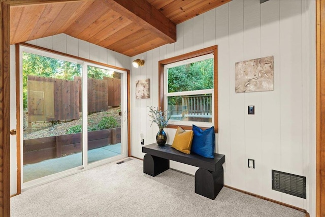 sunroom with wooden ceiling, a healthy amount of sunlight, and vaulted ceiling with beams