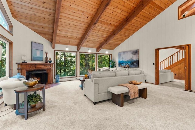 carpeted living room with high vaulted ceiling, wooden ceiling, wood walls, and beamed ceiling