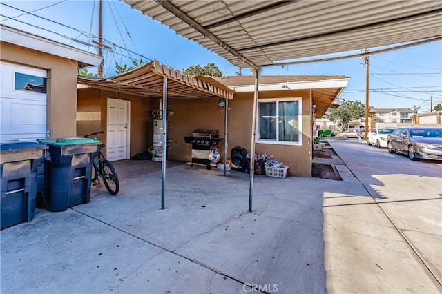 view of patio / terrace featuring gas water heater and a carport