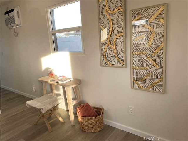 room details featuring hardwood / wood-style flooring and a wall unit AC