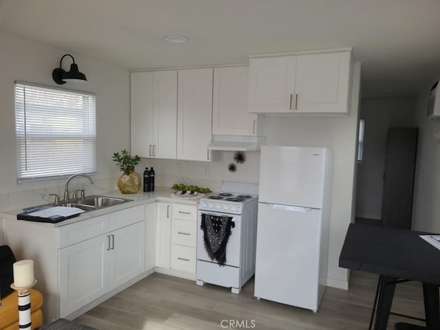 kitchen with white cabinets, white appliances, sink, and light hardwood / wood-style flooring