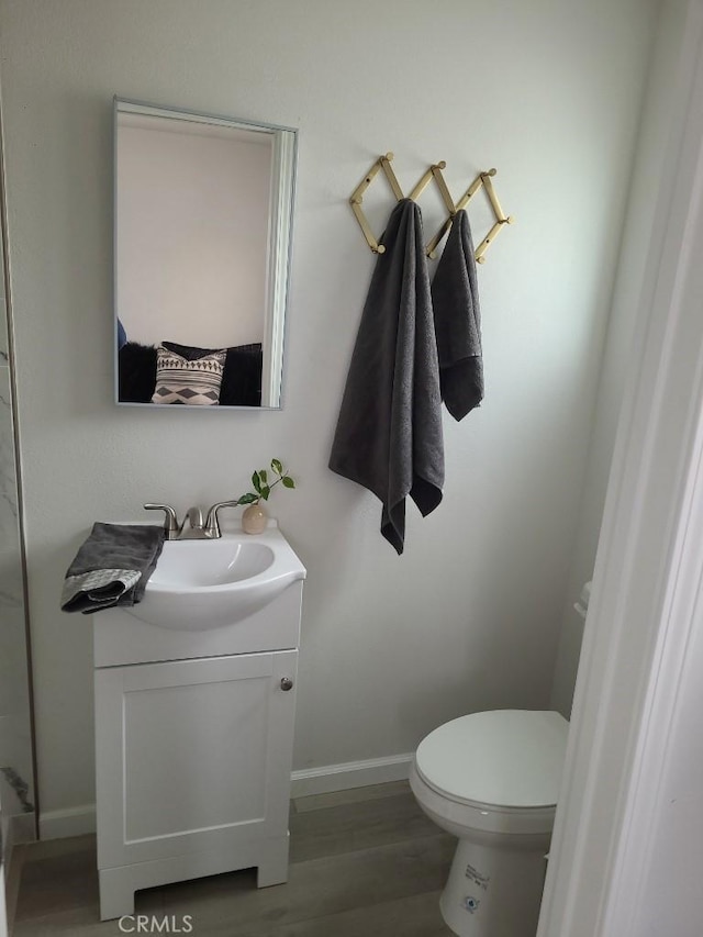 bathroom featuring hardwood / wood-style floors, vanity, and toilet