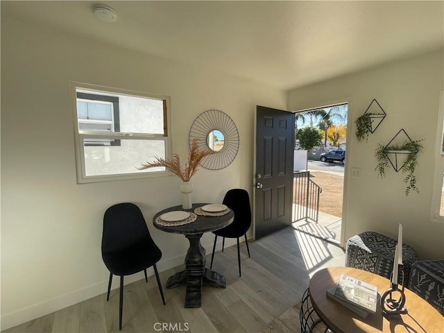 dining area with a healthy amount of sunlight and wood-type flooring