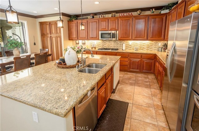 kitchen with pendant lighting, sink, an island with sink, and stainless steel appliances