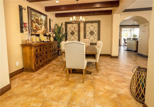 dining area with beamed ceiling and an inviting chandelier