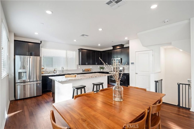 dining space with dark hardwood / wood-style flooring and sink