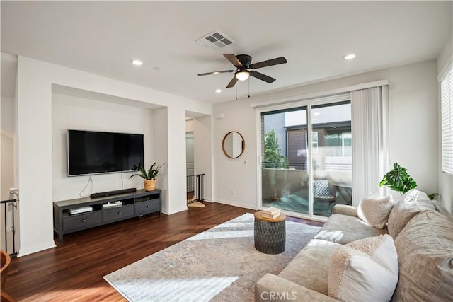 living room with dark hardwood / wood-style floors and ceiling fan