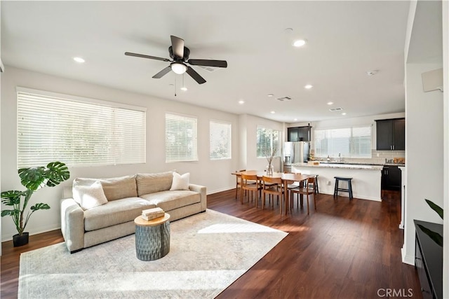 living room featuring dark hardwood / wood-style floors and ceiling fan