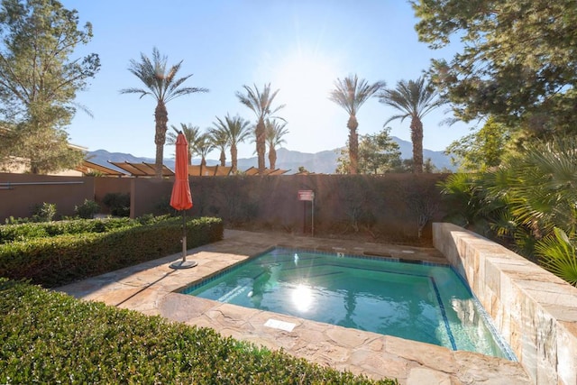 view of swimming pool with a mountain view