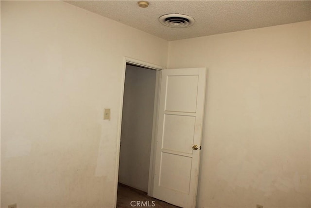 spare room with a textured ceiling